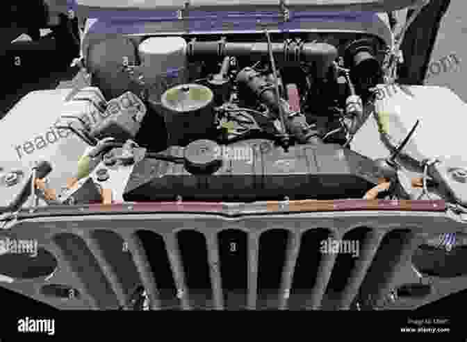 A Mechanic Working On The Engine Of A WWII Jeep, With Various Engine Parts Laid Out. Building A WWII Jeep: Finding Restoring And Rebuilding A Wartime Legend