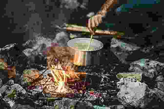 A Person Cooking Over A Campfire In The Woods Backwoods Home Magazine #134 Mar/Apr 2024